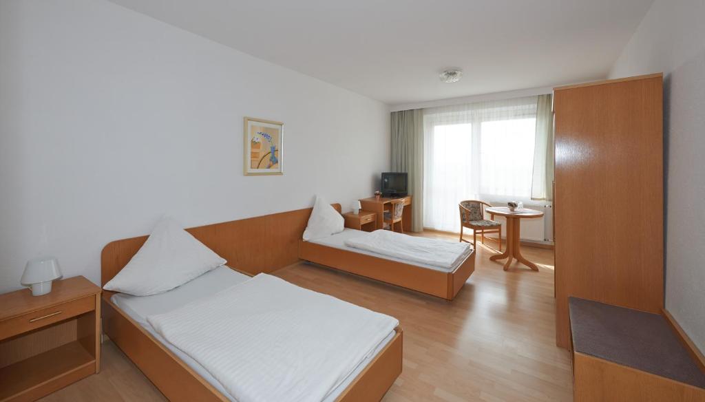 Postel nebo postele na pokoji v ubytování Alpha Apparthotel leipzig-Rötha