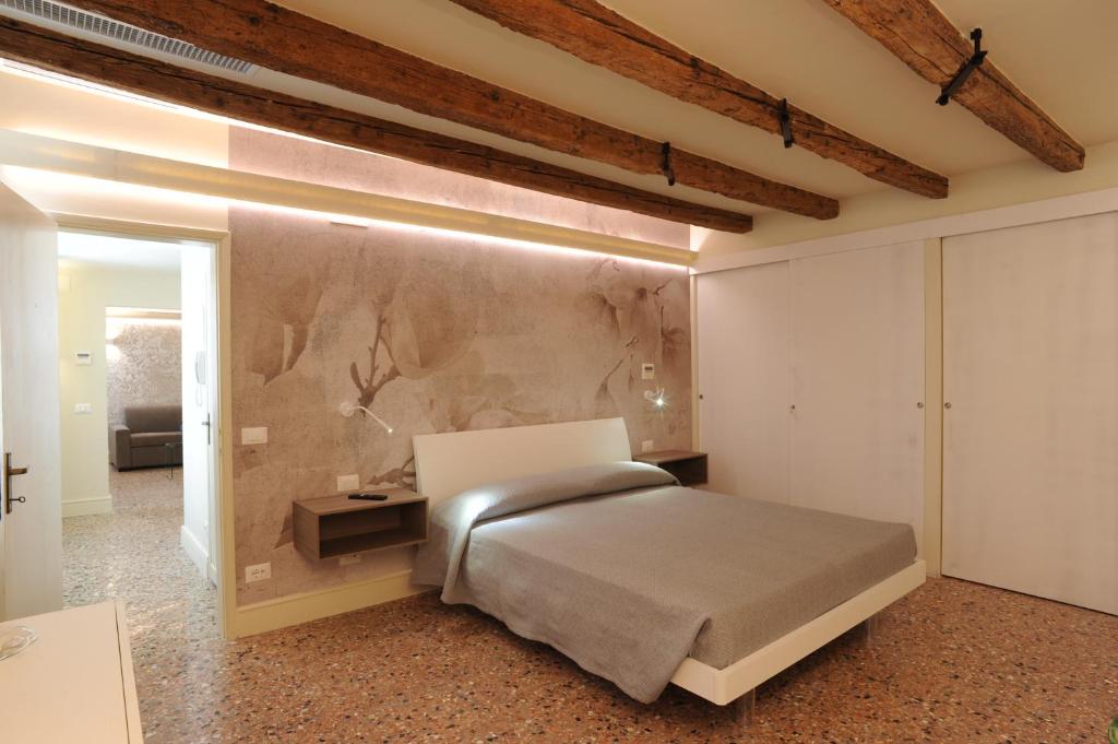 a bedroom with a bed and a wall at Cà Riva del Vin in Venice