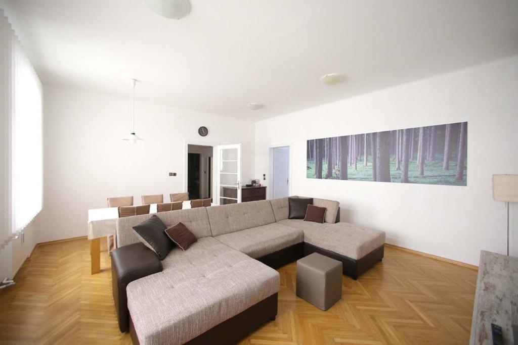 a living room with a couch and a table at Skyscraper Apartment Tour As Ljubljana in Ljubljana