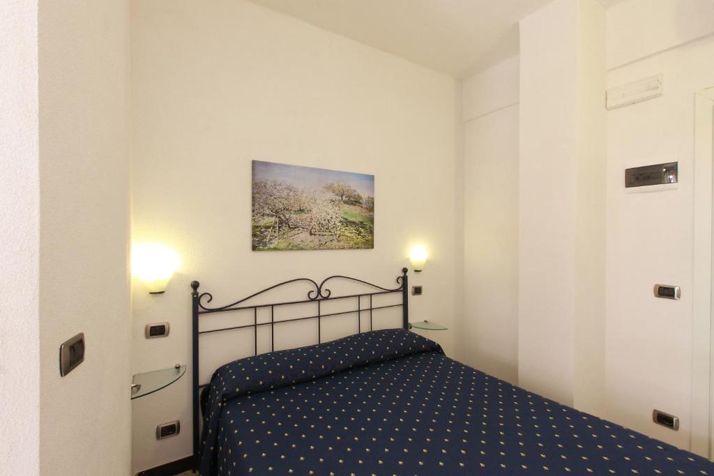 a bedroom with a bed in a white room at Albergo Al Carugio in Monterosso al Mare