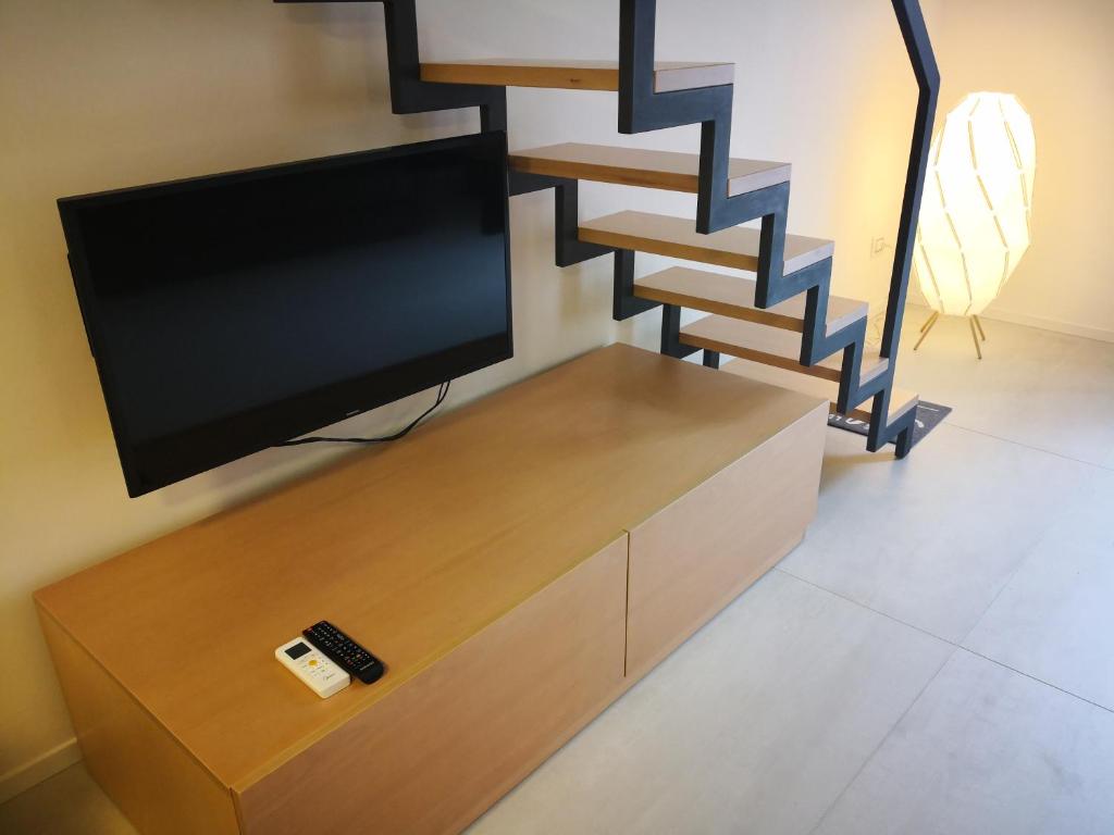 Televízia a/alebo spoločenská miestnosť v ubytovaní Casa Di Mamma