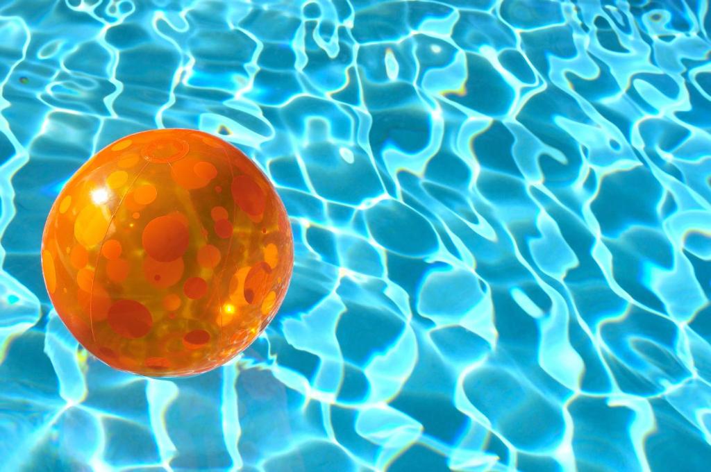 an orange ball floating in a pool of water at Saronic Citadel in Salamina