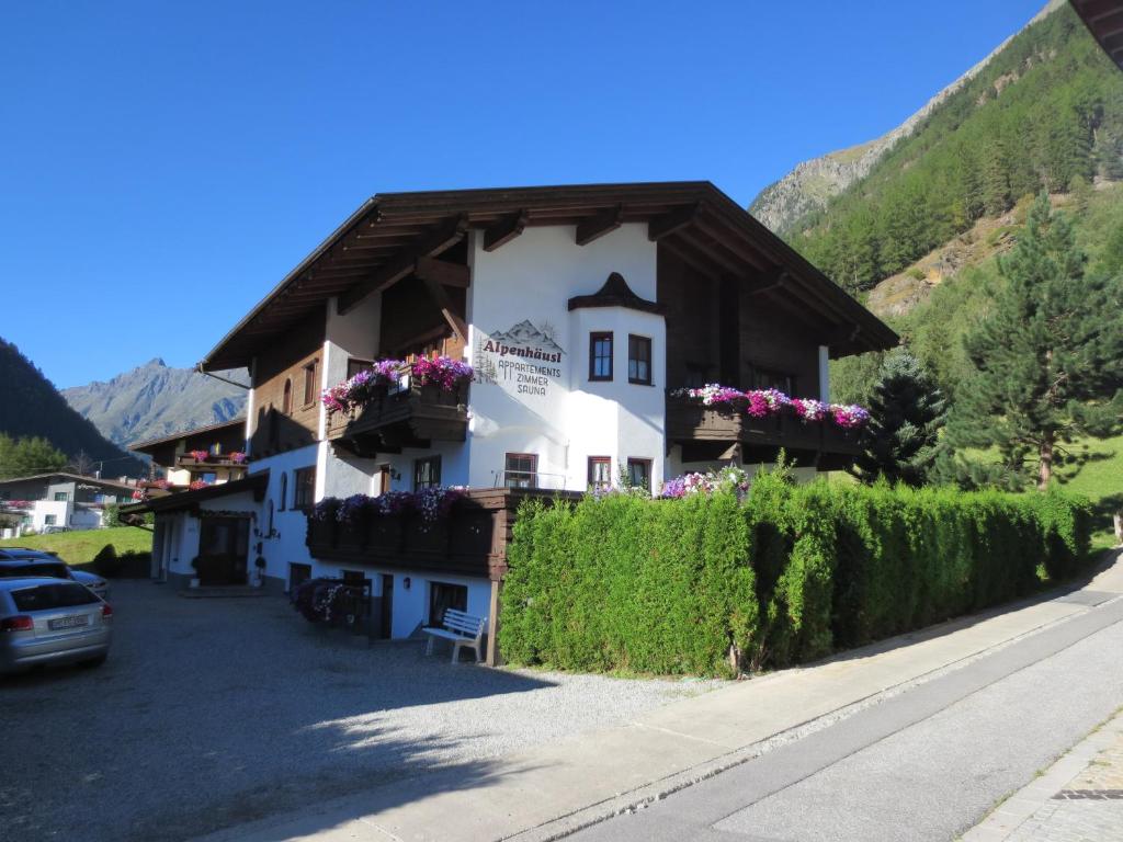 a building with flower boxes on the side of a street at Alpenhäusl in Sölden
