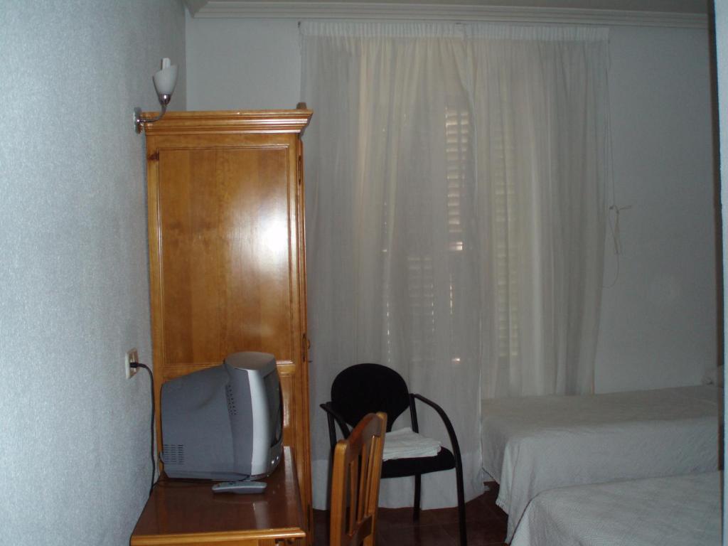 Postel nebo postele na pokoji v ubytování Hostal Castilla