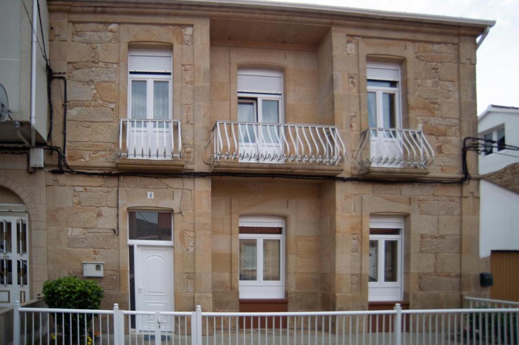een gebouw met balkons aan de zijkant bij Rakel in Muros