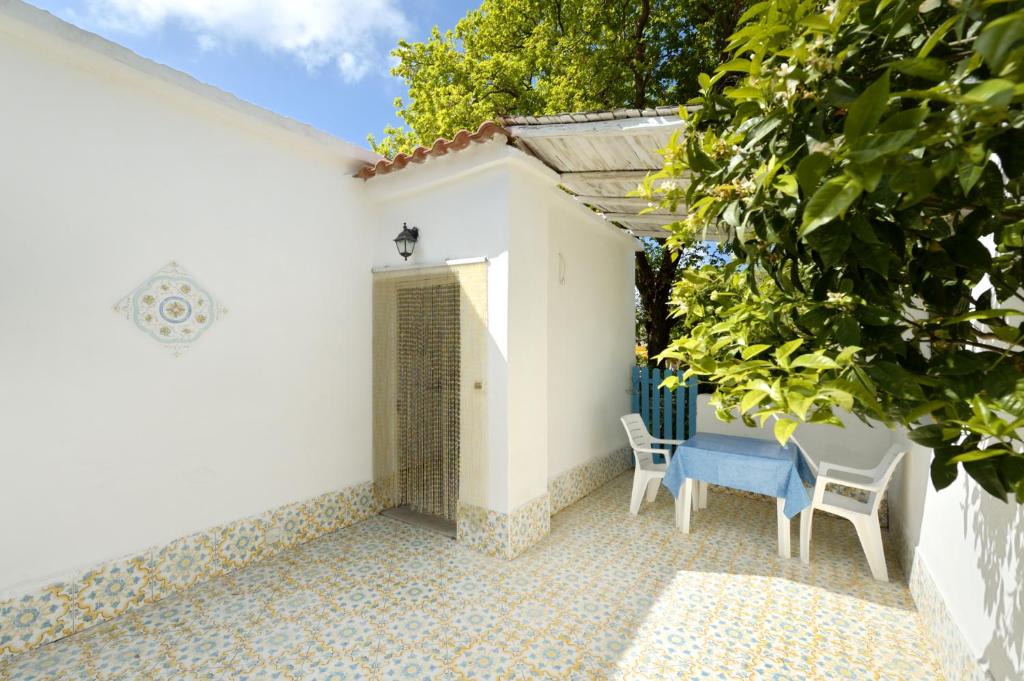 a patio with two chairs and a building at Le Querce in Procida