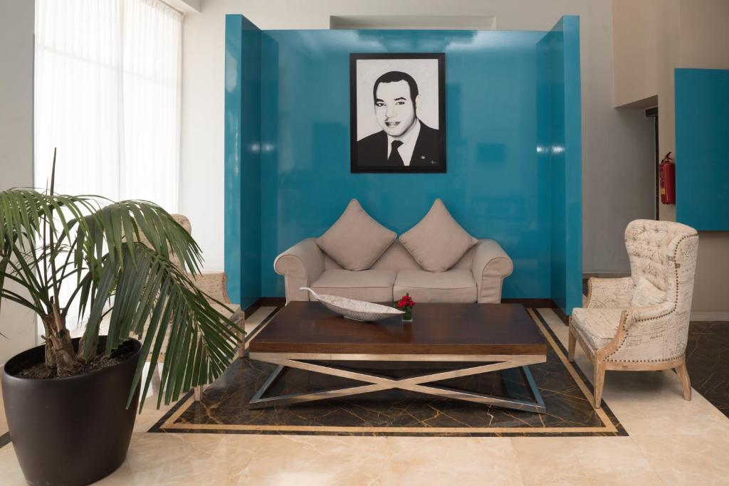 a living room with a couch and a table at ONOMO Hotel Rabat Terminus in Rabat