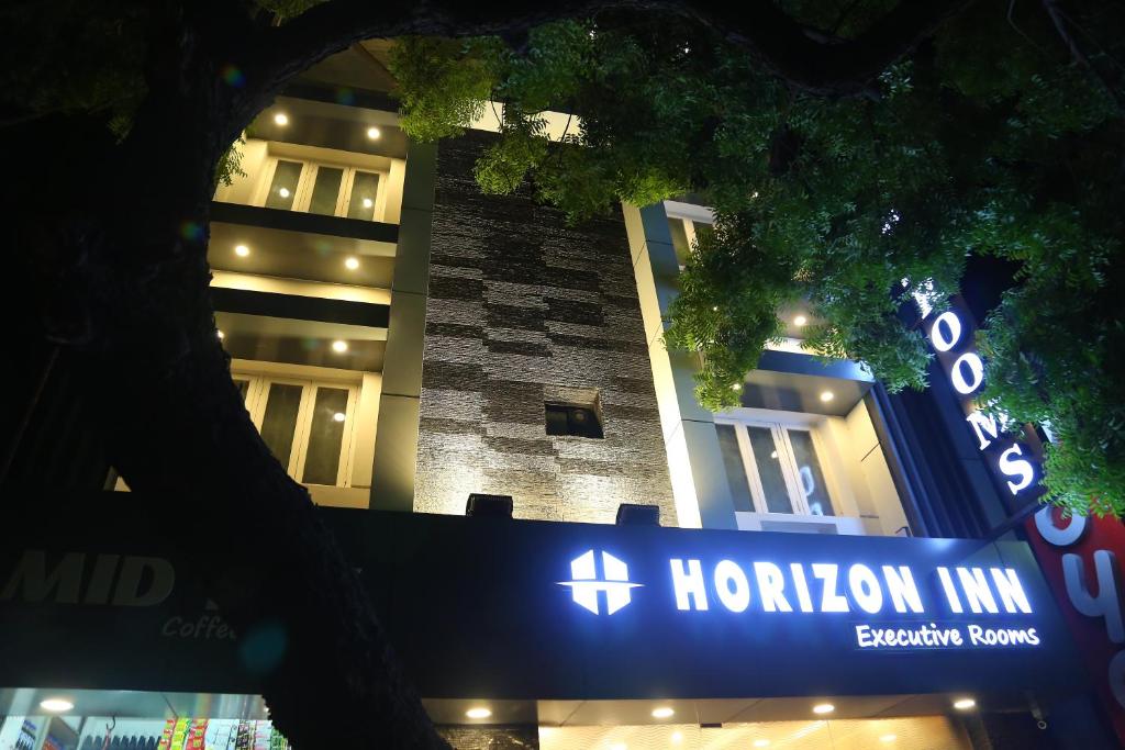 a hilton inn sign in front of a building at Horizon Inn in Chennai