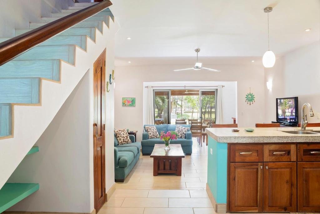 a living room with a staircase leading to a living room at Town House 9 in Iguana