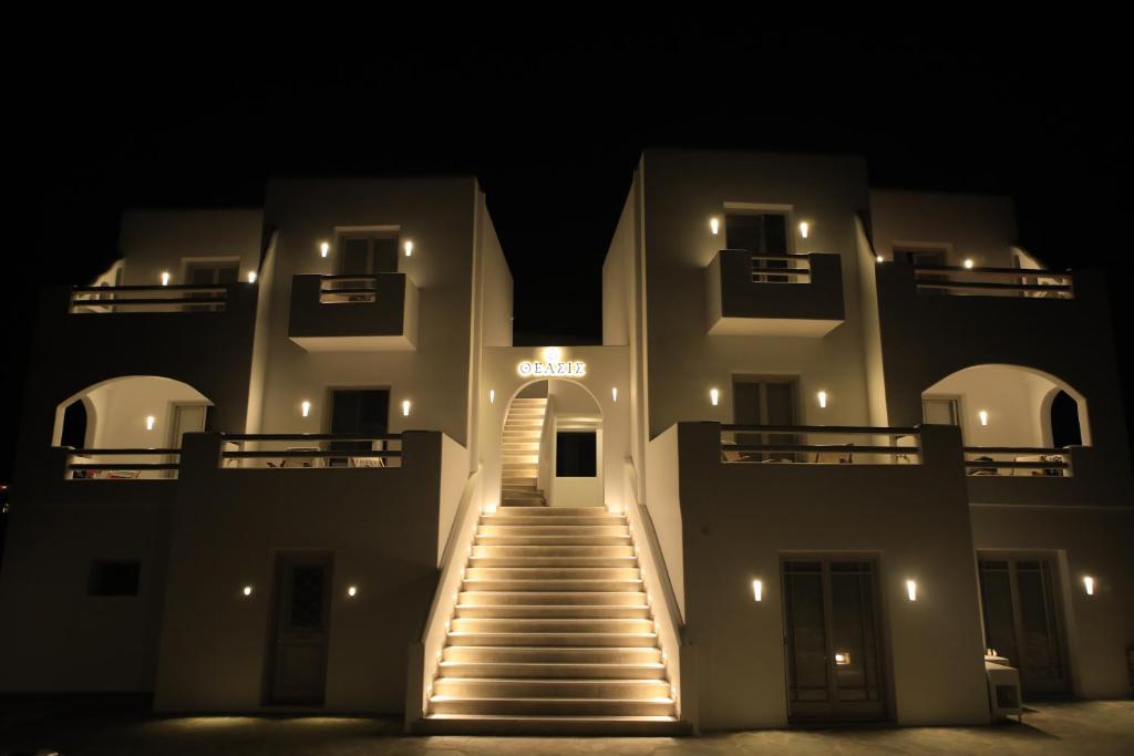 a lit up building with stairs in the dark at Theasis Luxury Suites in Skhoinoussa