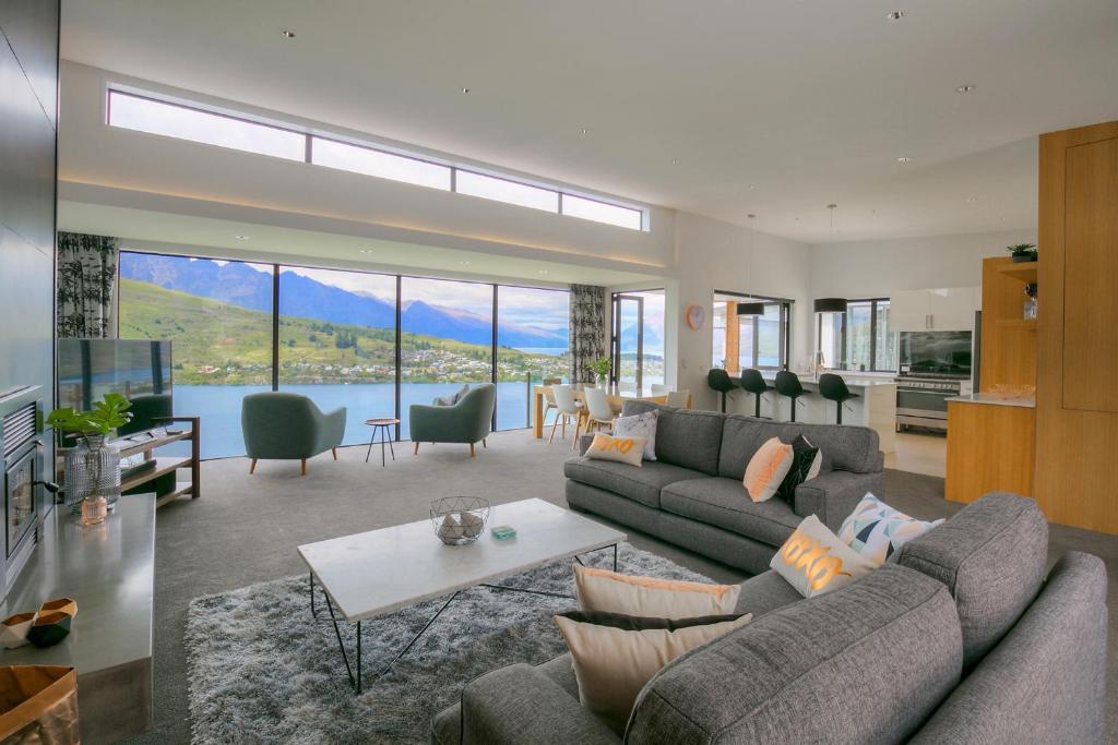 a living room with a couch and a table at Ultimate Views Luxury in Queenstown