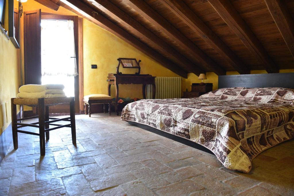 a bedroom with a bed and a table and a window at Il Palazzetto B&B in Viterbo