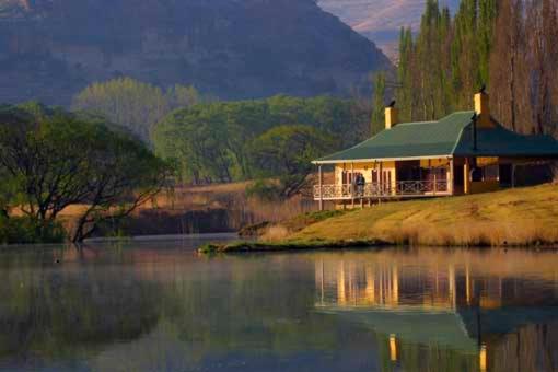 a house on an island in the middle of a lake at Royal Coachman in Clarens