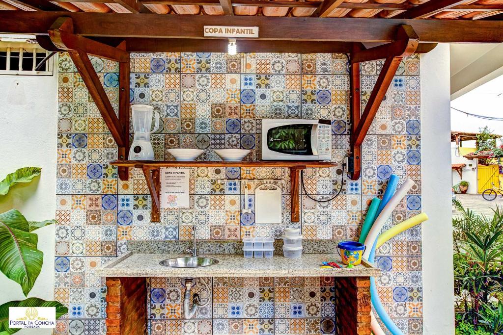 A cozinha ou cozinha compacta de Pousada Portal da Concha