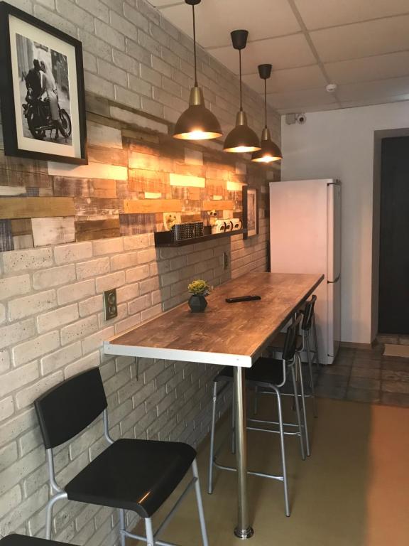 a kitchen with a wooden table and chairs at Horoshy Hostel in Chelyabinsk