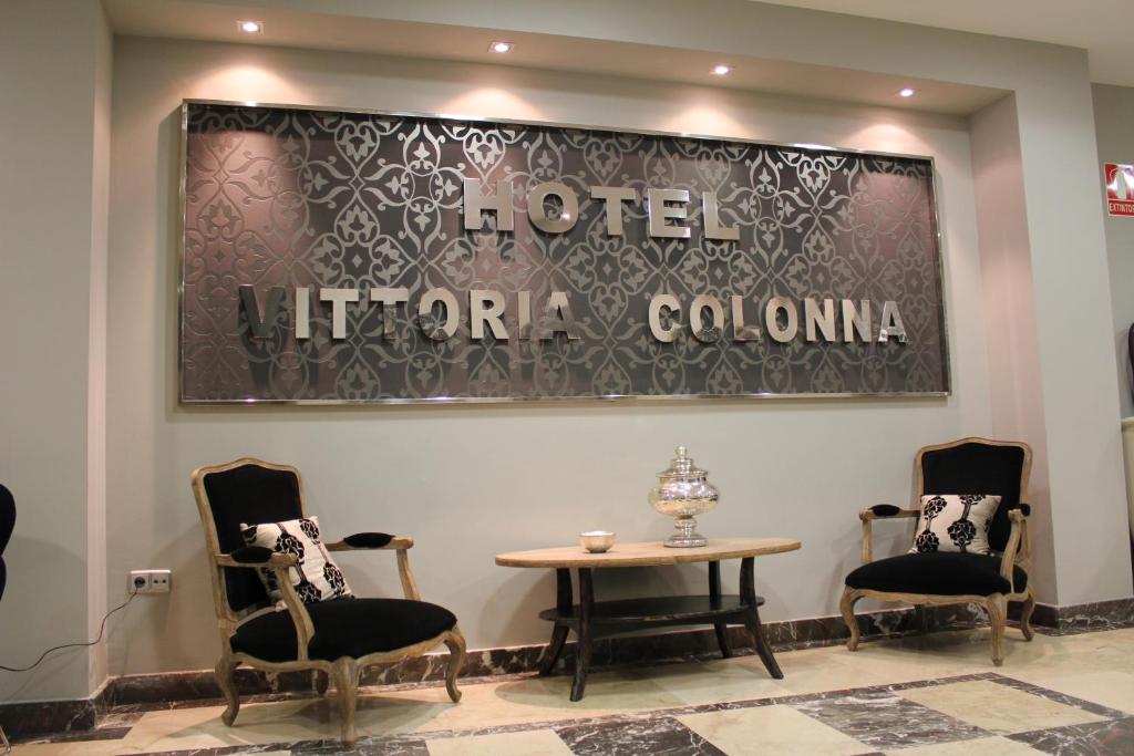 a waiting room with two chairs and a table at Hospedium Hotel Vittoria Colonna in Medina de Rioseco