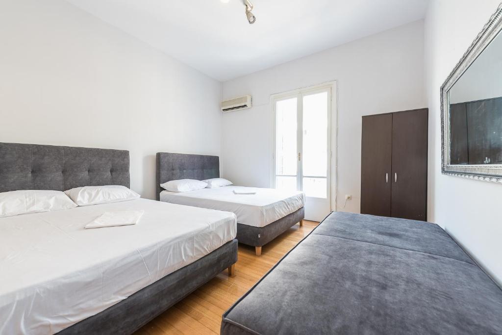 Łóżko lub łóżka w pokoju w obiekcie Victoria Majesty Apartments