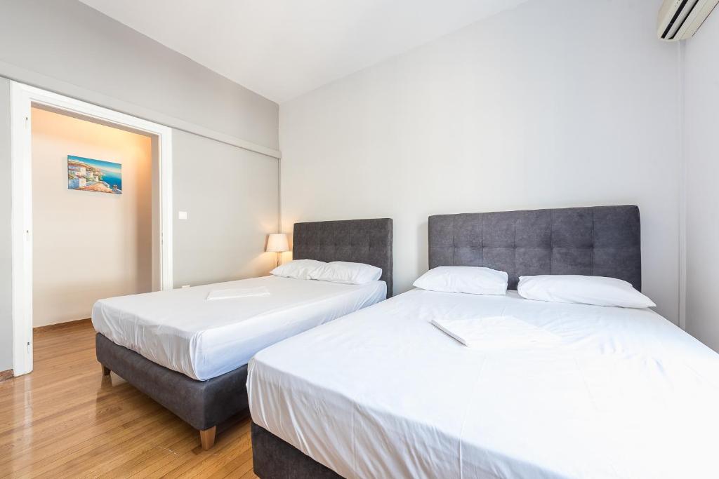 Łóżko lub łóżka w pokoju w obiekcie Victoria Majesty Apartments