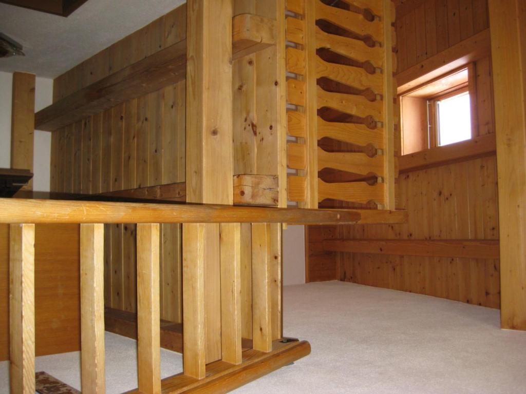 a room with wooden walls and a wooden table at Hotel Pizzeria Selva in Zernez