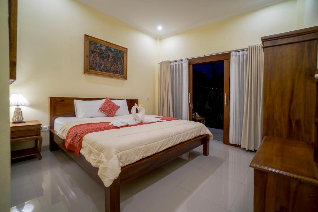 Postel nebo postele na pokoji v ubytování Omank Agus Homestay
