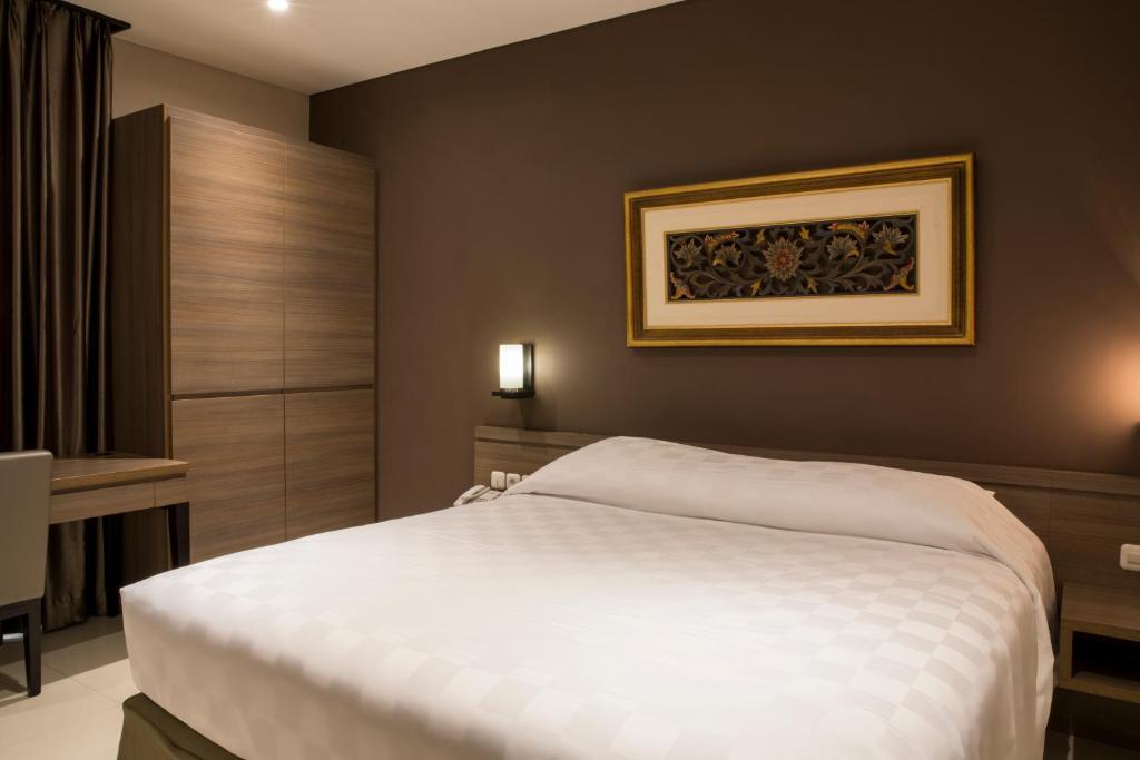 Postel nebo postele na pokoji v ubytování Mambruk Hotel & Convention