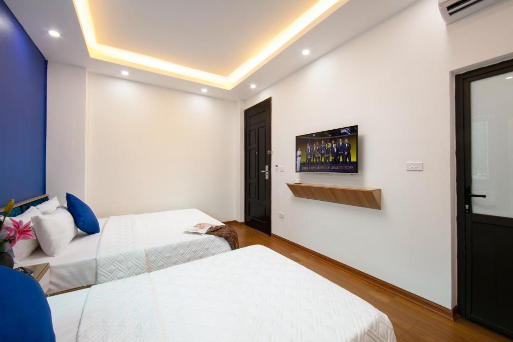 Postel nebo postele na pokoji v ubytování Hanoi Golden Hotel