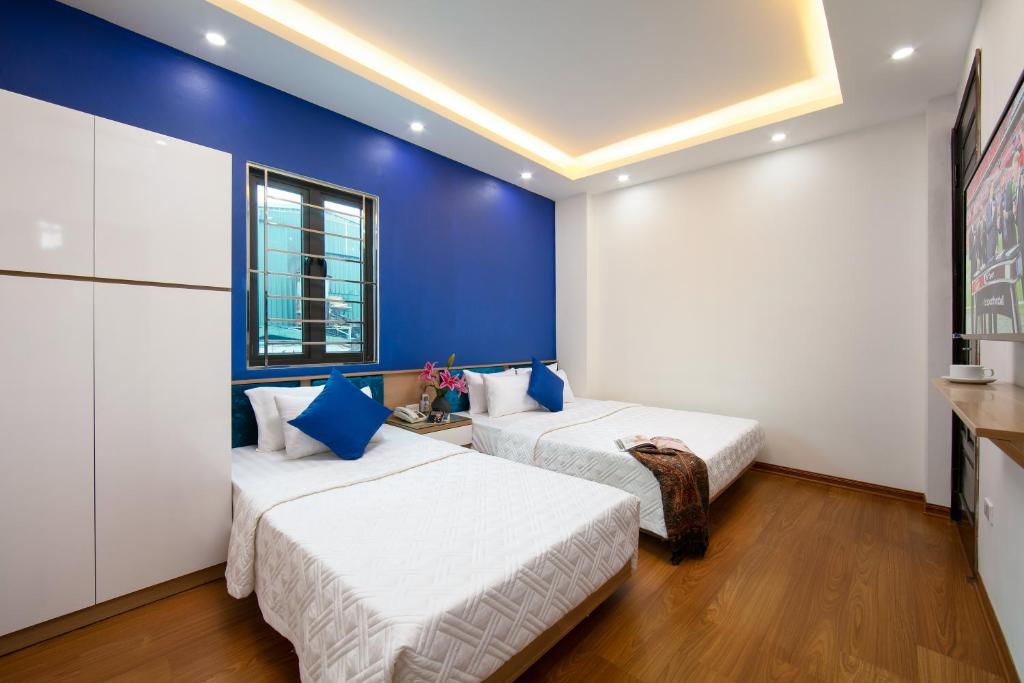 Postel nebo postele na pokoji v ubytování Hanoi Golden Hotel