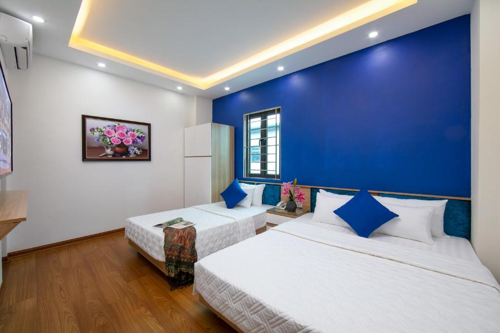 Postel nebo postele na pokoji v ubytování Hanoi Golden Hotel