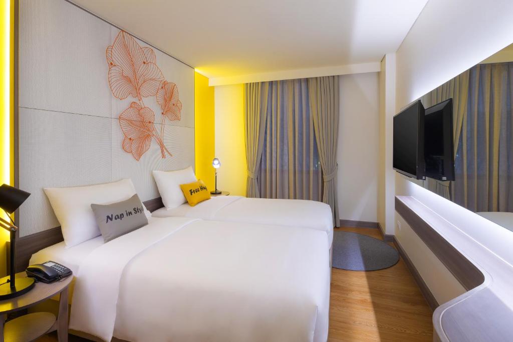 Postel nebo postele na pokoji v ubytování ibis Styles Siem Reap