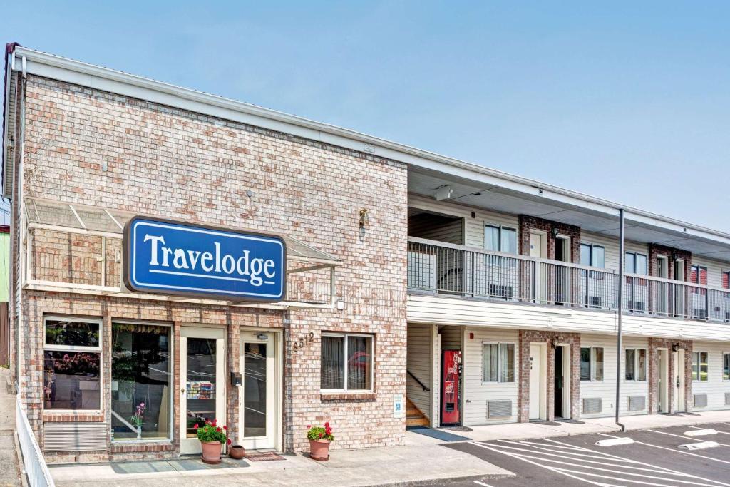 a large brick building with a sign for a travelodge at Travelodge by Wyndham Seattle North of Downtown in Seattle