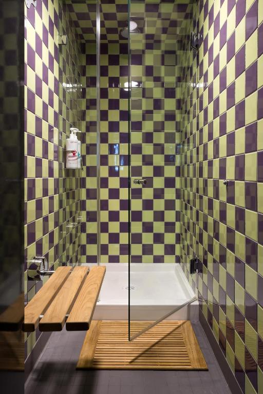 a shower with a glass door in a bathroom at Pangea Pod Hotel in Whistler