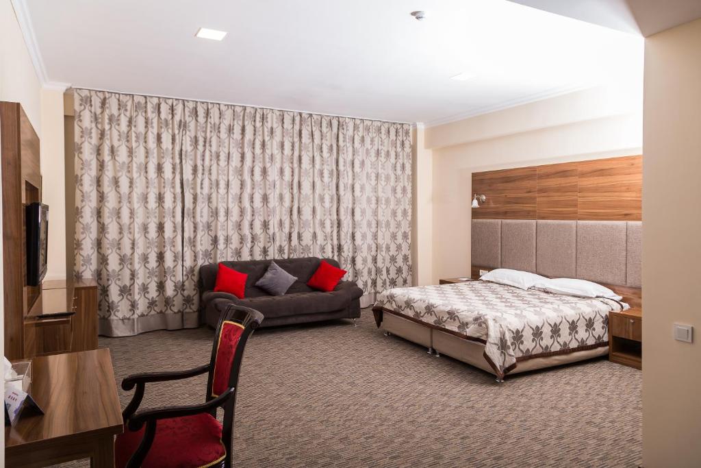 
Кровать или кровати в номере Гранд отель Евразия
