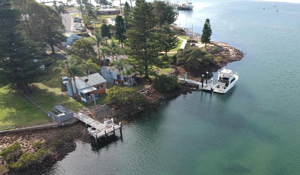 a boat is docked at a dock in the water at Waterfront Cottages in Greenwell Point