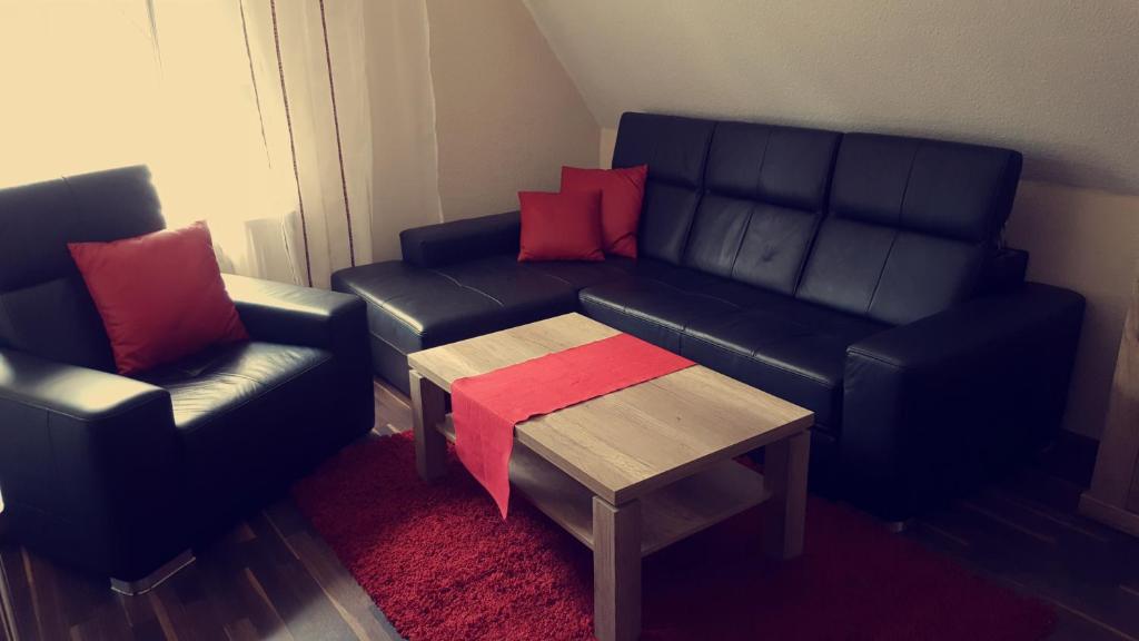 a living room with a couch and two chairs and a table at uebernachtung unna in Unna