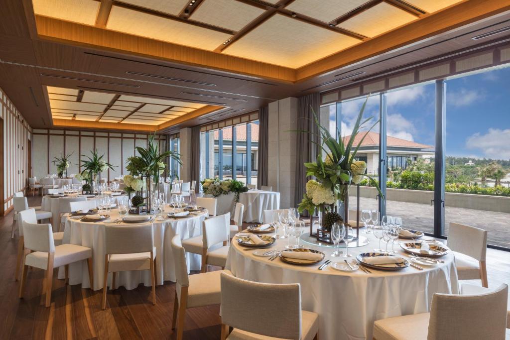 a conference room with tables and chairs and windows at Hyatt Regency Seragaki Island Okinawa in Onna