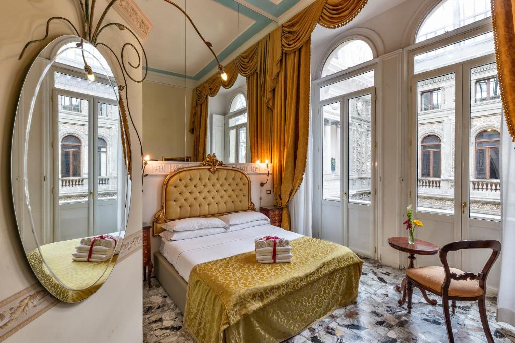 a bedroom with a bed and a mirror at B&B Art Suite Santa Brigida in Naples