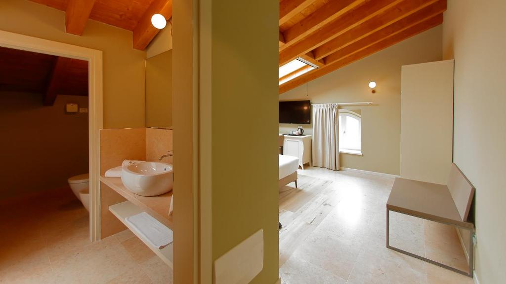Postel nebo postele na pokoji v ubytování Le Greghe Suites