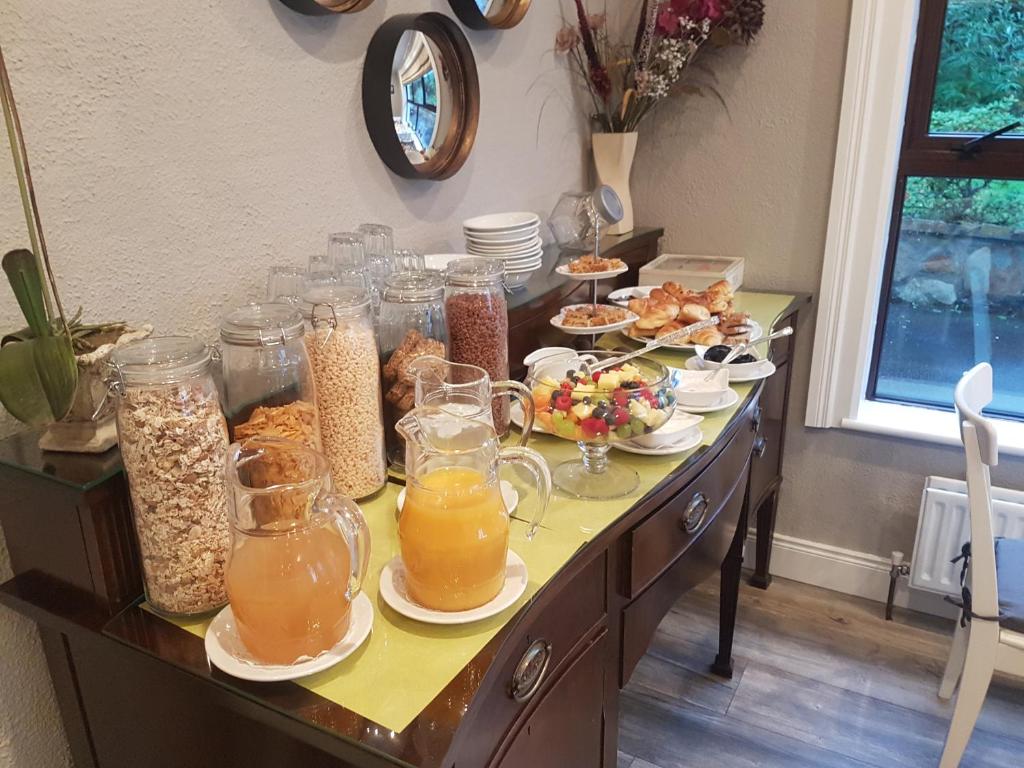 a table filled with food and jars of orange juice at Ben Breen House B&B in Clifden