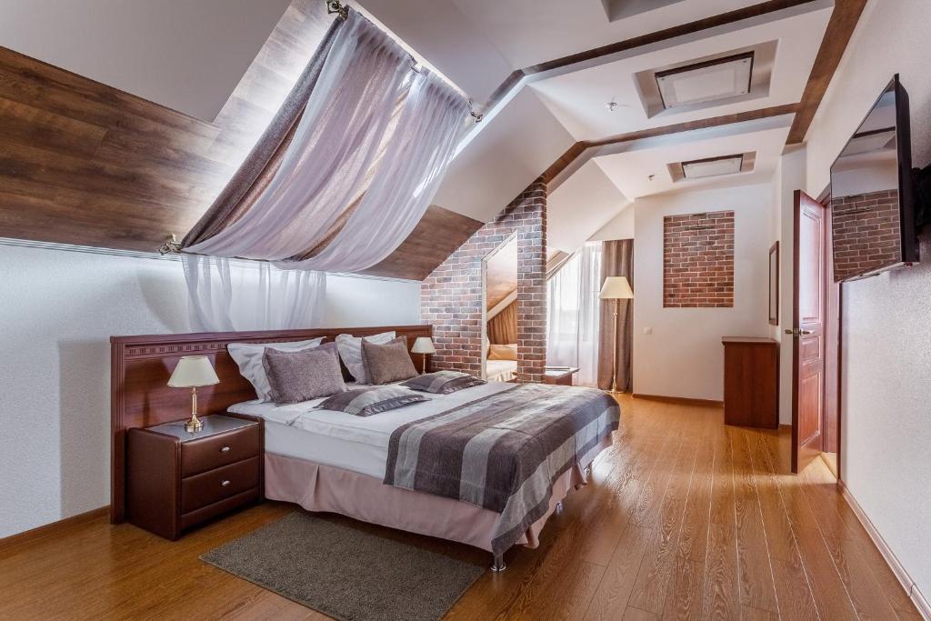 a bedroom with a large bed in a room at Hotel Yuzhnaya Bashnya in Krasnodar