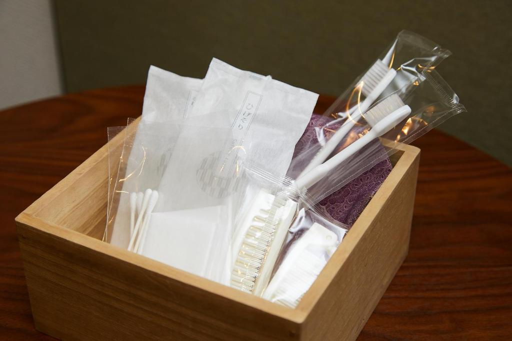 a wooden box filled with toothbrushes and other items at Rinn Gion Kenninji in Kyoto