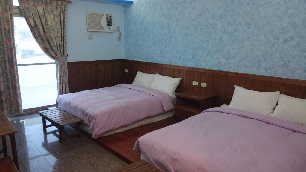 Postel nebo postele na pokoji v ubytování Umin Chu Inn