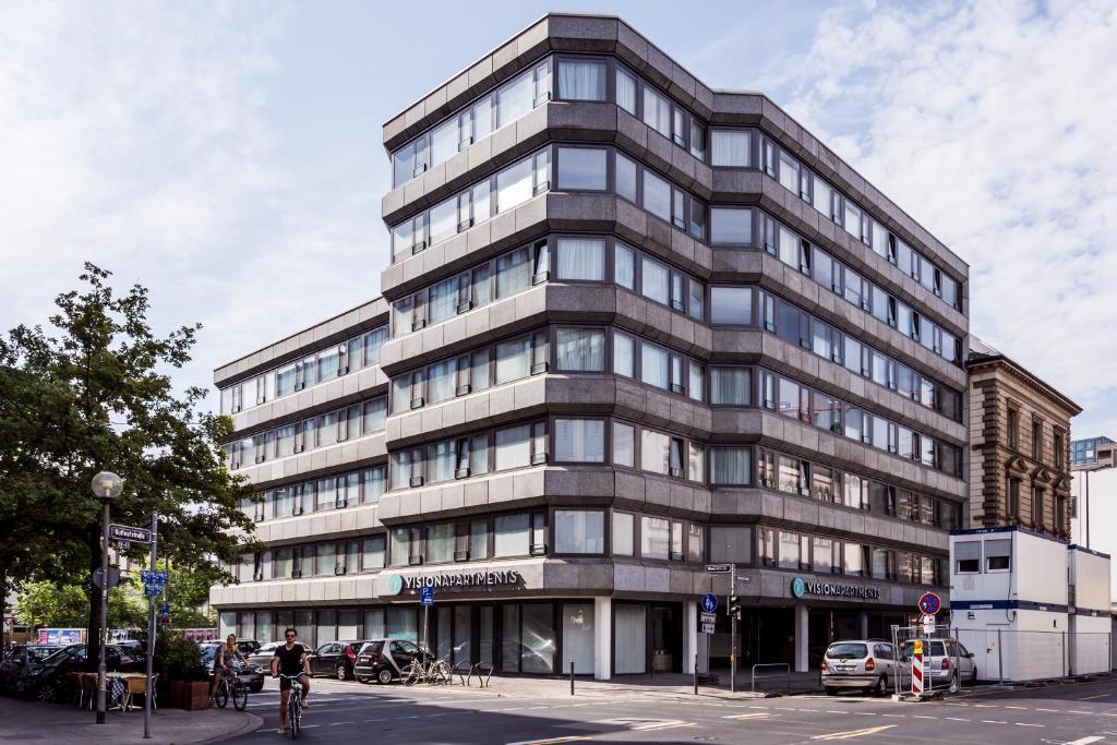 a tall gray building on a city street at VISIONAPARTMENTS Gutleutstrasse - contactless check-in in Frankfurt