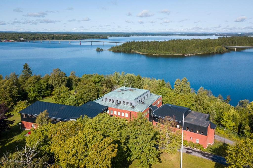 Holmsund的住宿－Västerbacken Hotell & Konferens，享有湖岸上建筑物的空中景致