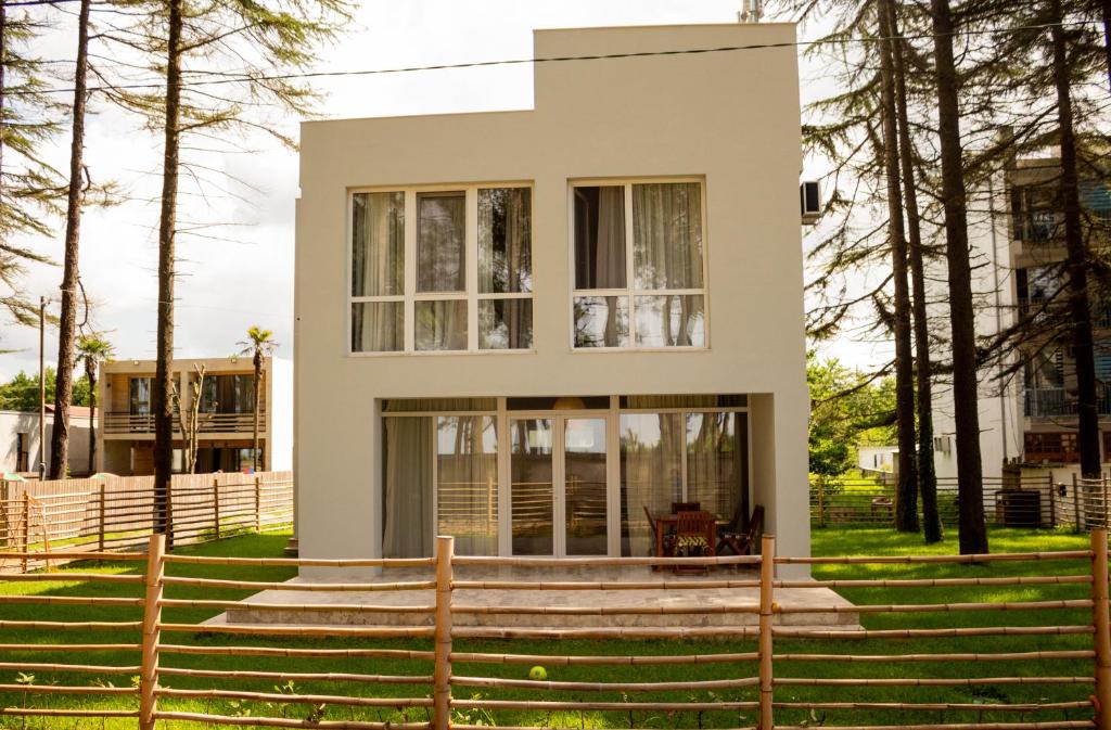 a house with a staircase in front of it at Villa by the Sea in Shekvetili