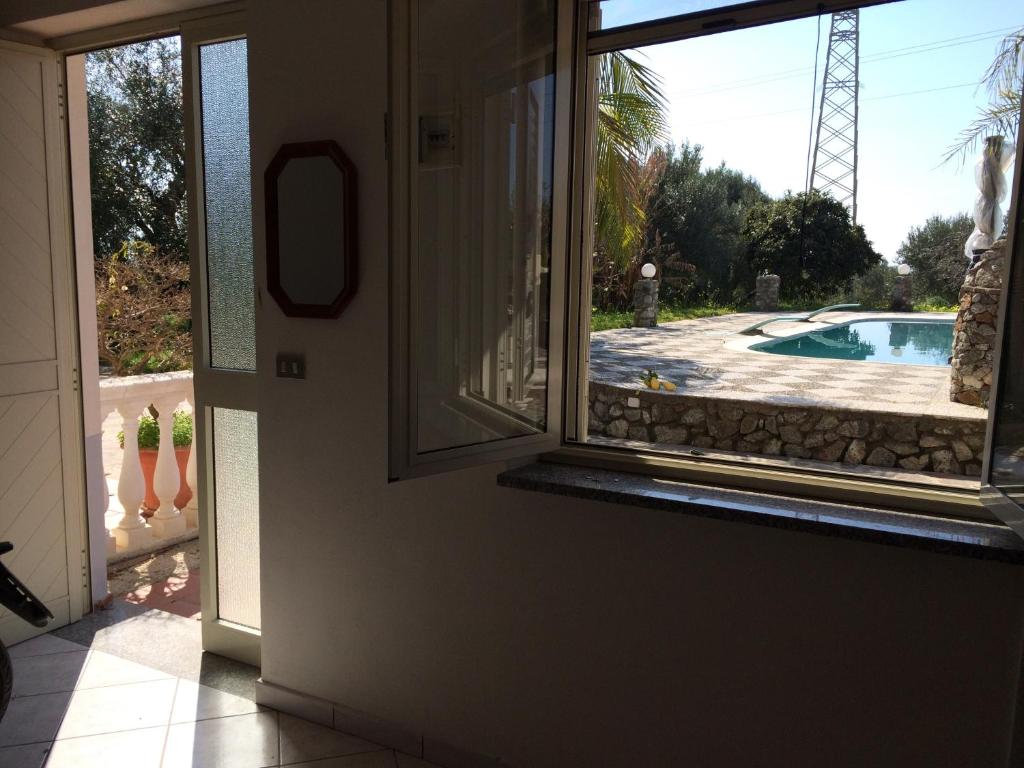 a view of a pool through a window at Hotel Royal in Coccorino