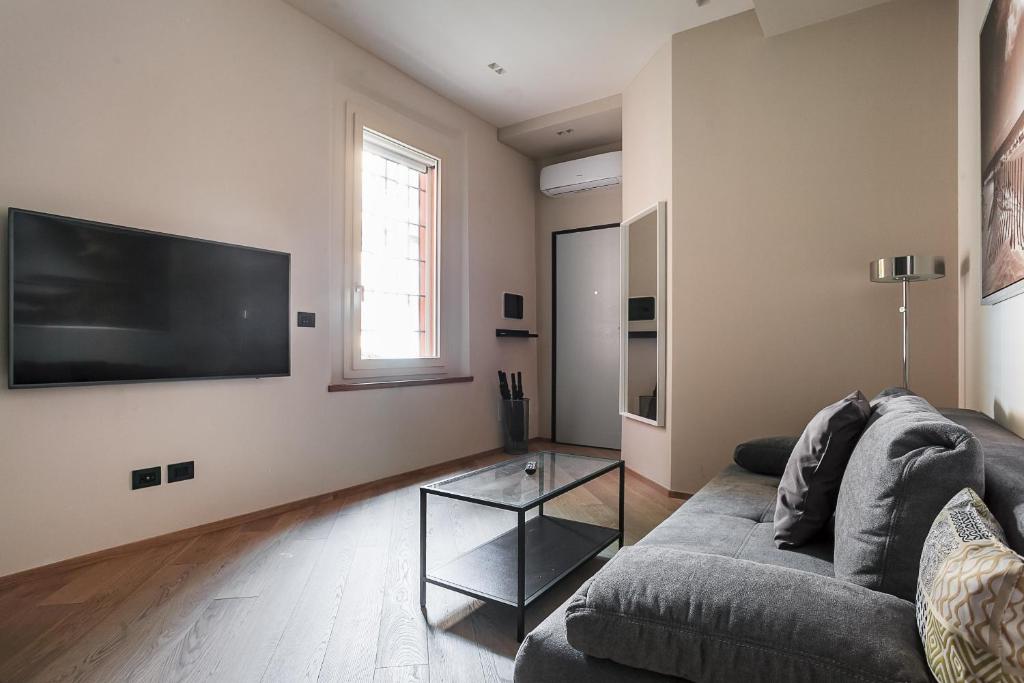 Telewizja i/lub zestaw kina domowego w obiekcie Residence Rizzoli-Suites Apartments