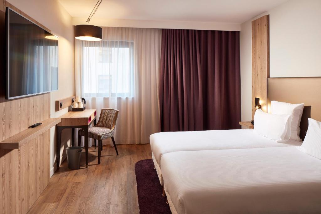 Postel nebo postele na pokoji v ubytování Hôtel Maison Turenne