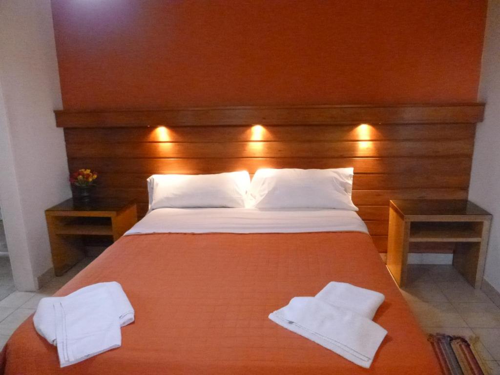 a bedroom with a large bed with two towels on it at Las Balsas Hotel in Federación