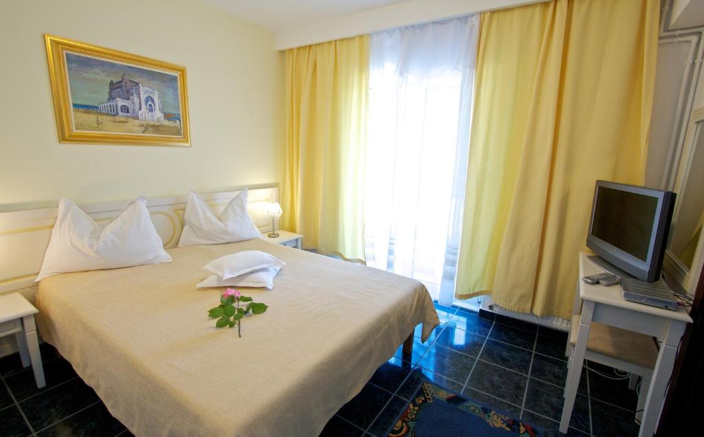 Postel nebo postele na pokoji v ubytování Hotel Central