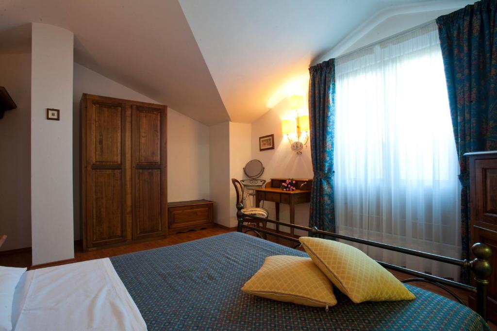 Postel nebo postele na pokoji v ubytování Albergo La Lanterna